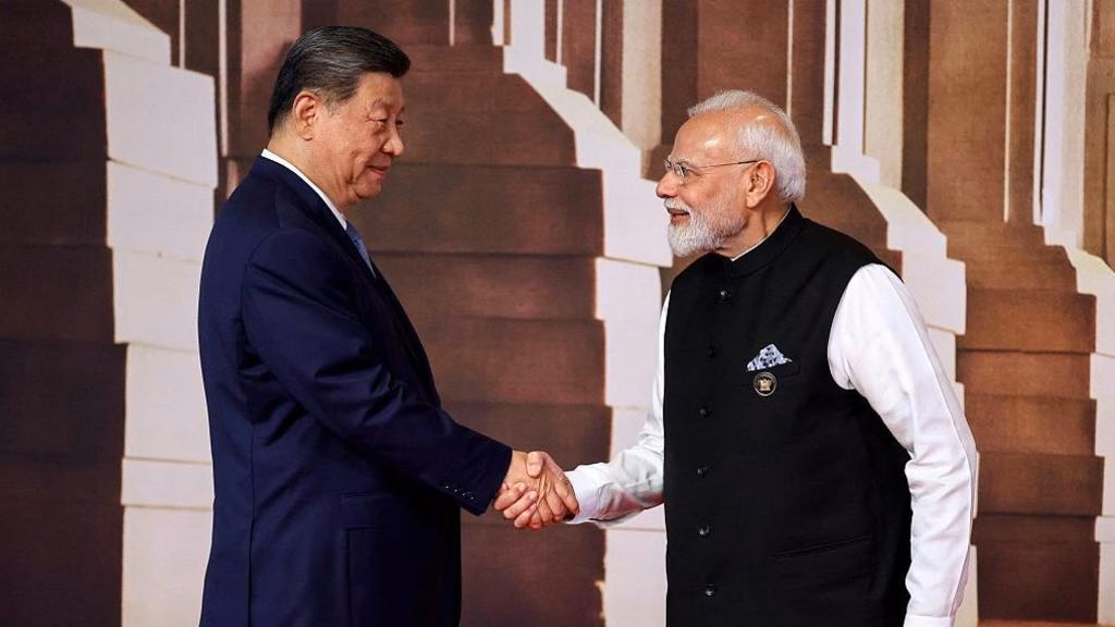 India's Prime Minister Narendra Modi (R) shakes hands with China's President Xi Jinping before the start of the 18th BRICS Summit in Delhi on 18 September 2026.