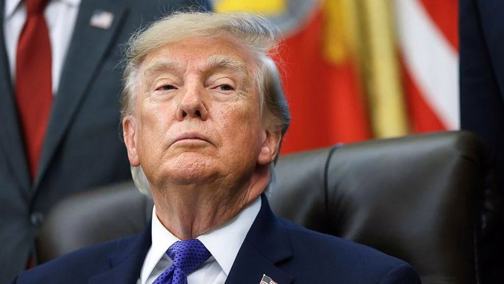 US President Donald Trump listens to a reporters question in the Oval Office at the White House
